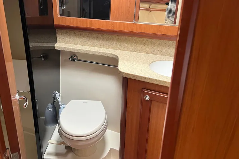 Slide: The Image of 2007 Luhrs 41 Hardtop yacht bathroom with wooden cabinetry and modern fixtures. - 9