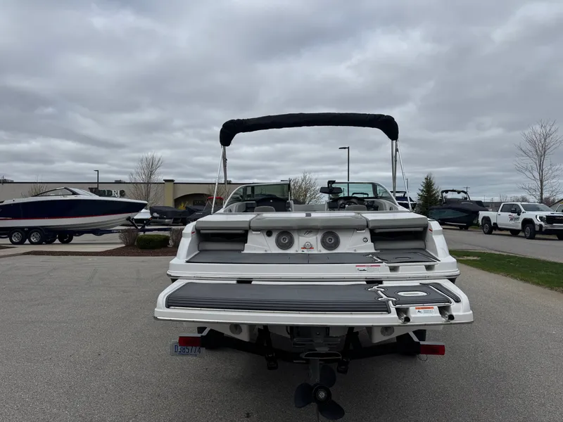 Slide: The Image of Rear view of a 2016 Four Winns 190 Horizon boat in a parking lot. - 7