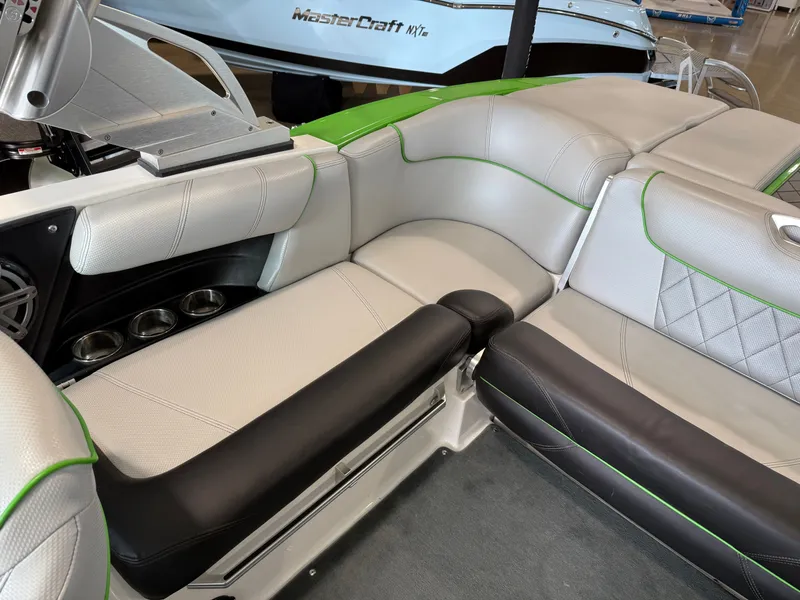 Slide: The Image of Interior of a 2015 MasterCraft X10 boat with gray and green seating. - 10