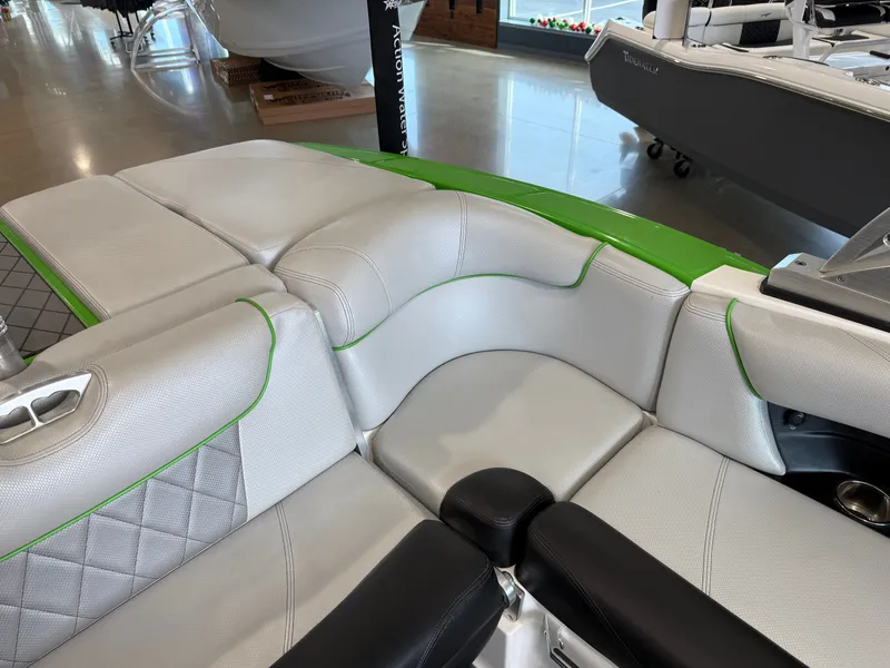 Slide: The Image of Interior of a 2015 MasterCraft X10 boat with gray and green upholstery. - 16