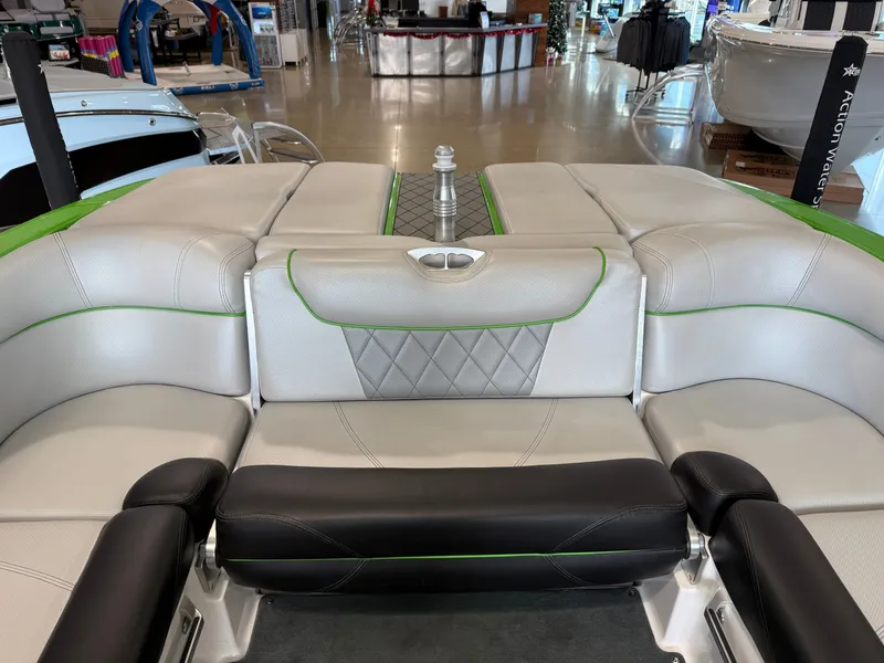 Slide: The Image of Interior of a 2015 MasterCraft X10 boat with gray and green seating. - 17