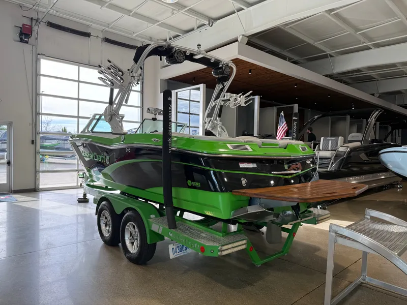 Slide: The Image of Green 2015 MasterCraft X10 boat in a showroom. - 3