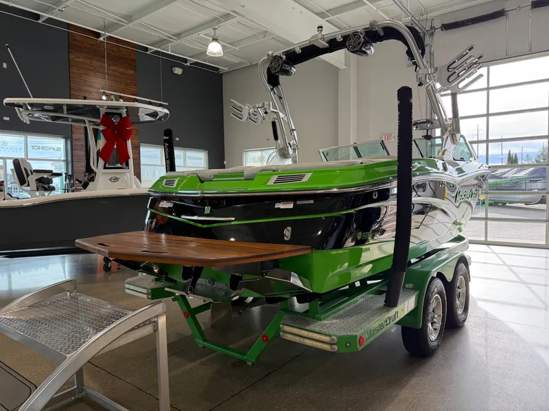Slide: The Image of Green 2015 MasterCraft X10 boat in showroom. - 4