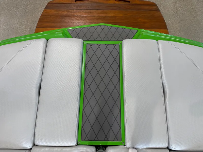 Slide: The Image of Rear view of a 2015 MasterCraft X10 boat with green accent. - 9