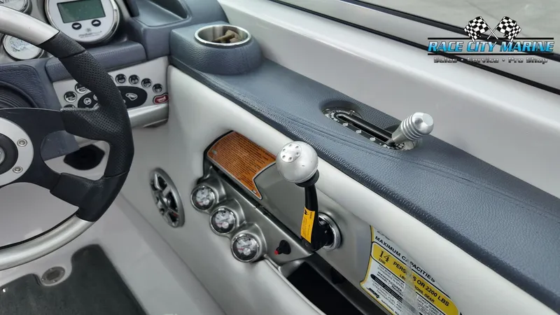 Slide: The Image of Interior of a 2007 Correct Craft 236TE boat with controls. - 12