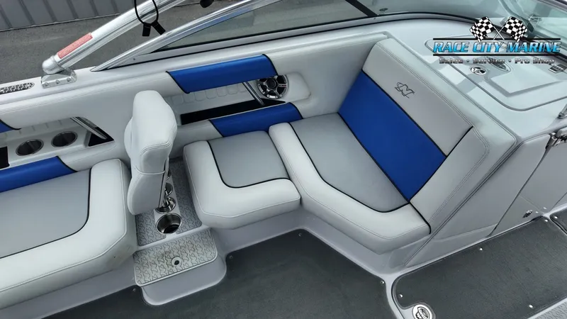Slide: The Image of Interior of a 2007 Correct Craft 236TE boat with blue and gray seating. - 13