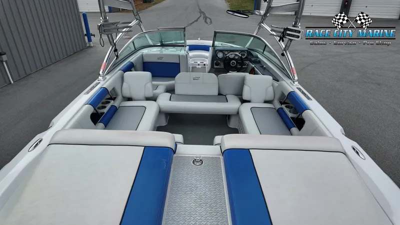 Slide: The Image of Interior view of a 2007 Correct Craft 236TE boat, blue and white upholstery. - 16