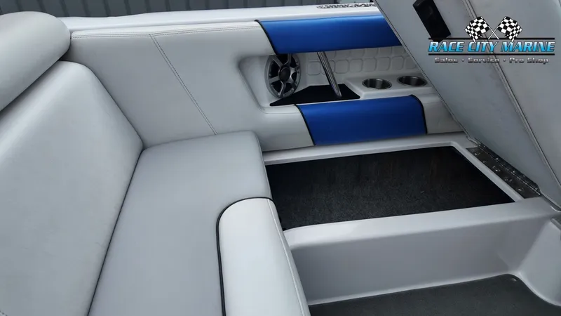 Slide: The Image of Interior of a 2007 Correct Craft 236TE boat with blue accents. - 18