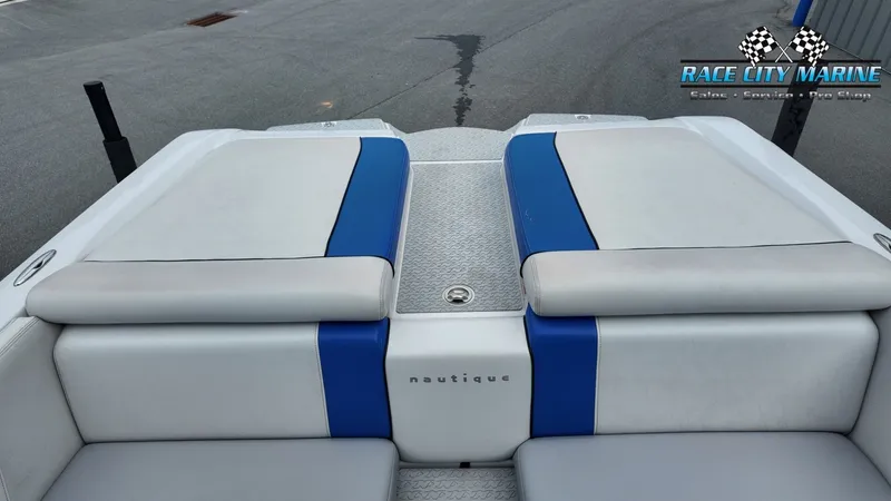 Slide: The Image of Rear view of a 2007 Correct Craft 236TE boat with blue and white upholstery. - 23
