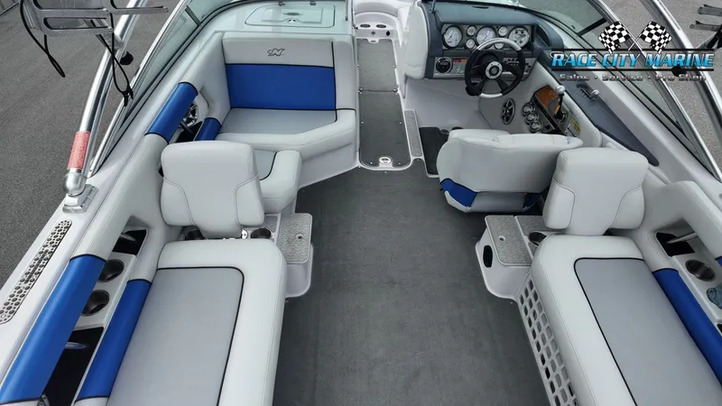 Slide: The Image of Interior of a 2007 Correct Craft 236TE boat with blue and gray seating. - 29