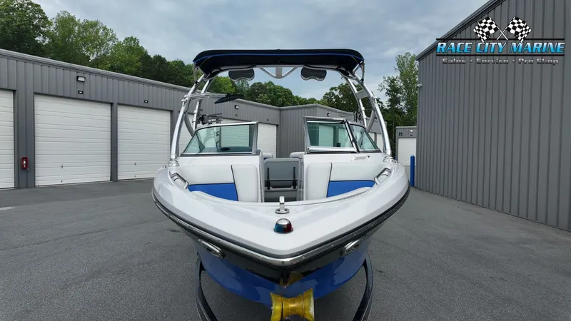 Slide: The Image of 2007 Correct Craft 236TE boat in front of storage buildings. - 3