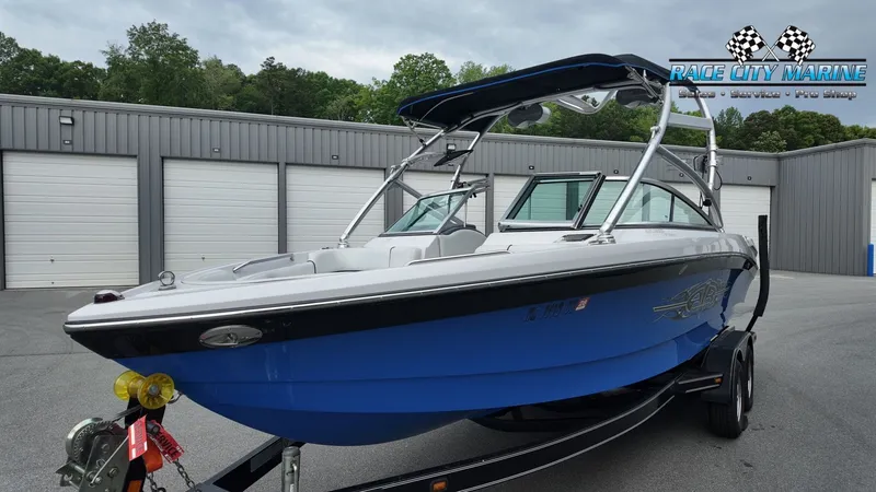 Slide: The Image of 2007 Correct Craft 236TE boat in front of storage building. - 6