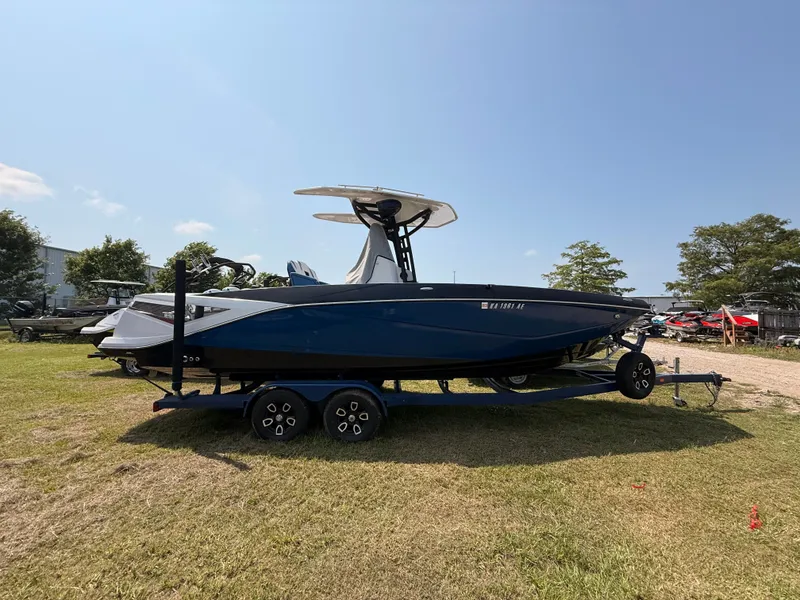 Slide: The Image of 2019 Scarab 255 Open ID boat on trailer outdoors. - 11