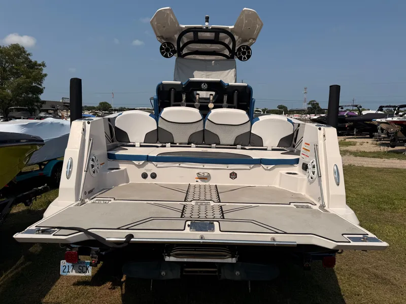 Slide: The Image of Rear view of a 2019 Scarab 255 Open ID boat on grass. - 14