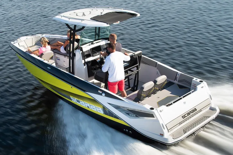 Slide: The Image of 2019 Scarab 255 Open ID boat on water with passengers. - 19