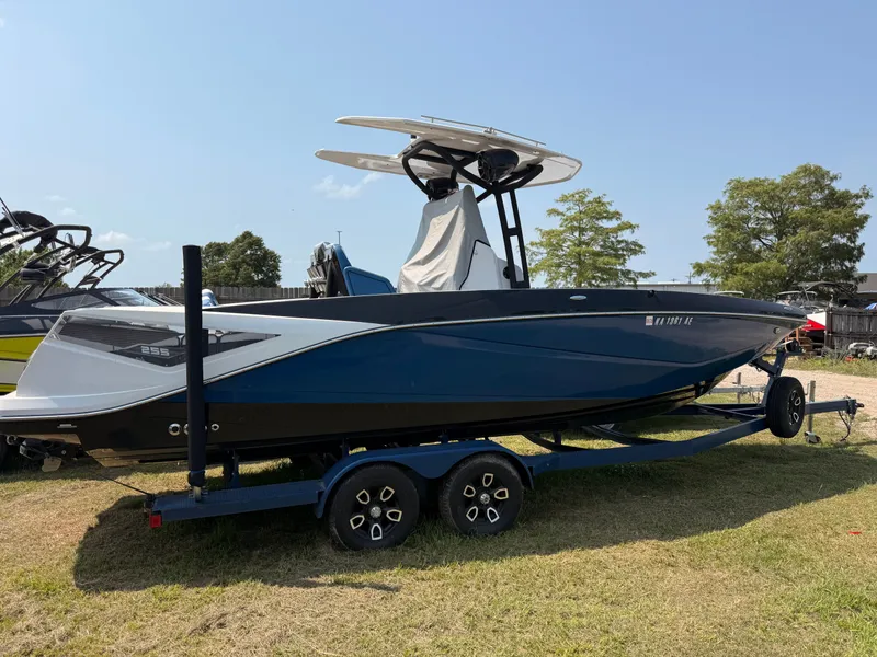 Slide: The Image of 2019 Scarab 255 Open ID boat on trailer outdoors. - 4