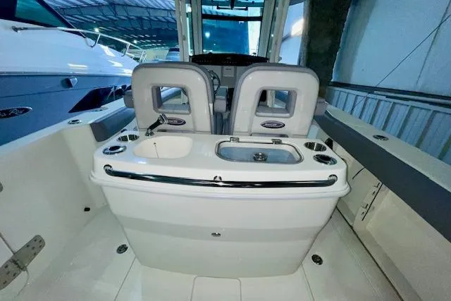 Slide: The Image of 2024 Boston Whaler 280 Outrage boat interior with seating and console. - 10