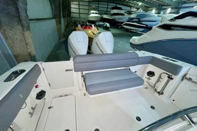 Slide: The Image of 2024 Boston Whaler 280 Outrage boat interior with dual engines in a storage facility. - 11