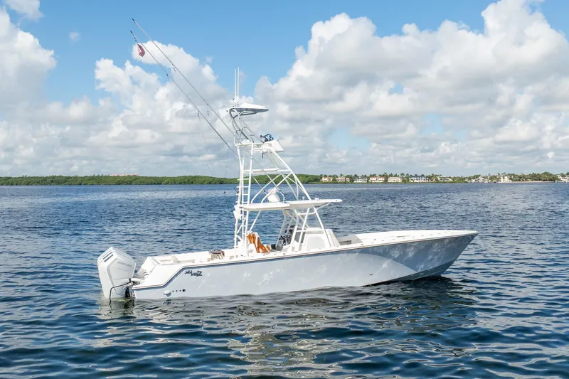 The Image of 2024 SeaVee 400Z boat on calm water under a partly cloudy sky. - 0