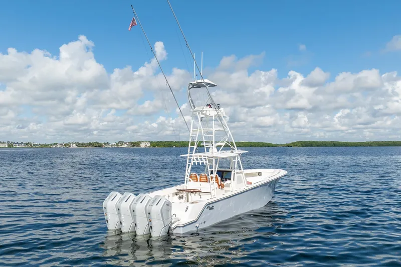 Slide: The Image of 2024 SeaVee 400Z boat with multiple engines on a calm sea under a blue sky. - 22