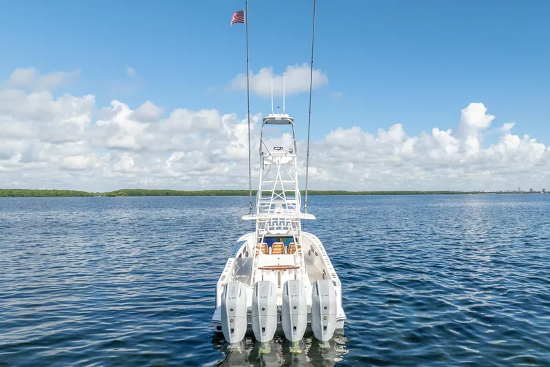 Slide: The Image of 2024 SeaVee 400Z boat on calm water, featuring multiple outboard engines and a clear blue sky. - 23