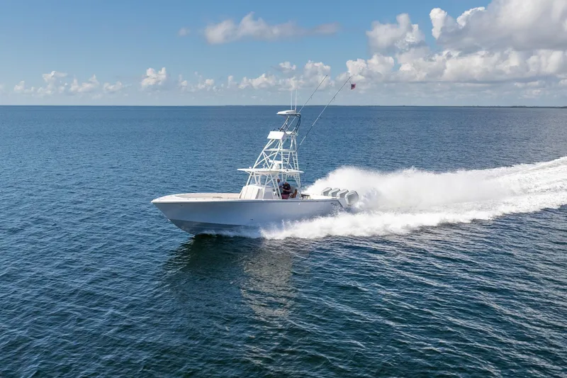 Slide: The Image of 2024 SeaVee 400Z boat cruising on open ocean under clear skies. - 24