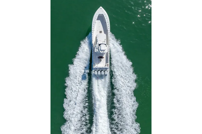 Slide: The Image of Aerial view of 2024 SeaVee 400Z boat cruising on green water. - 26
