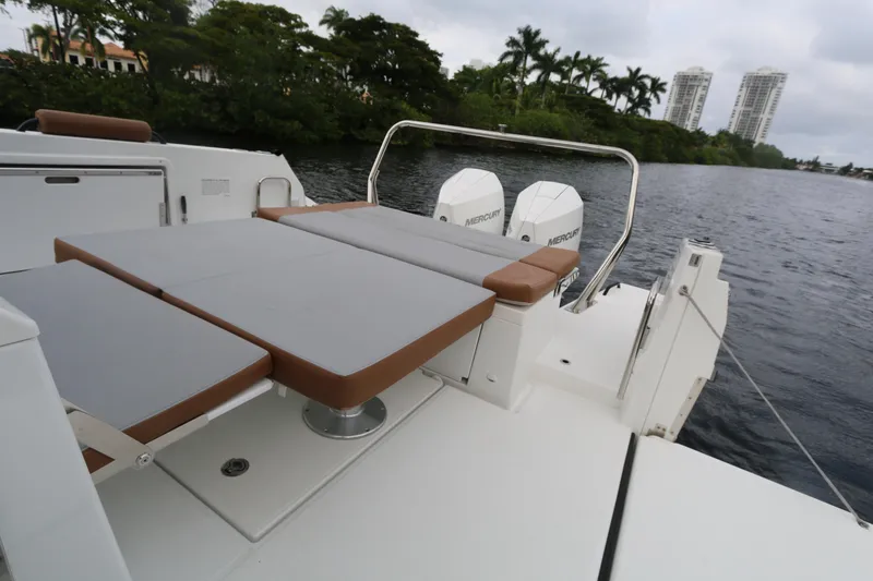 Slide: The Image of 2022 Beneteau Flyer 9 SPACEdeck with dual Mercury engines on a serene waterway. - 11