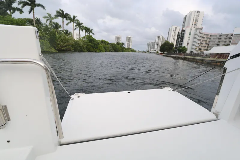Slide: The Image of 2022 Beneteau Flyer 9 SPACEdeck on a river with cityscape and palm trees. - 14