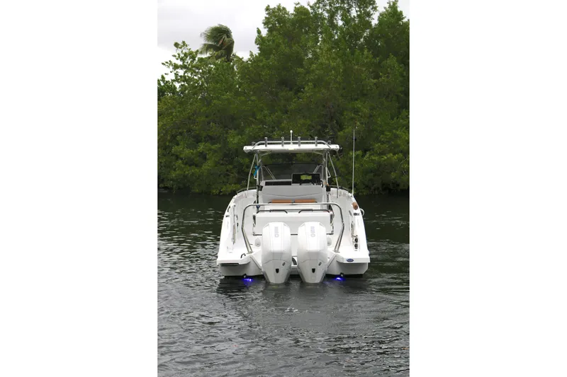 Slide: The Image of 2022 Beneteau Flyer 9 SPACEdeck boat with dual engines on a calm waterway. - 17