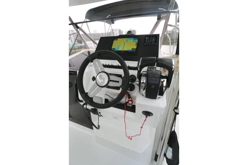 Slide: The Image of Helm of 2022 Beneteau Flyer 9 SPACEdeck with steering wheel and navigation controls. - 2