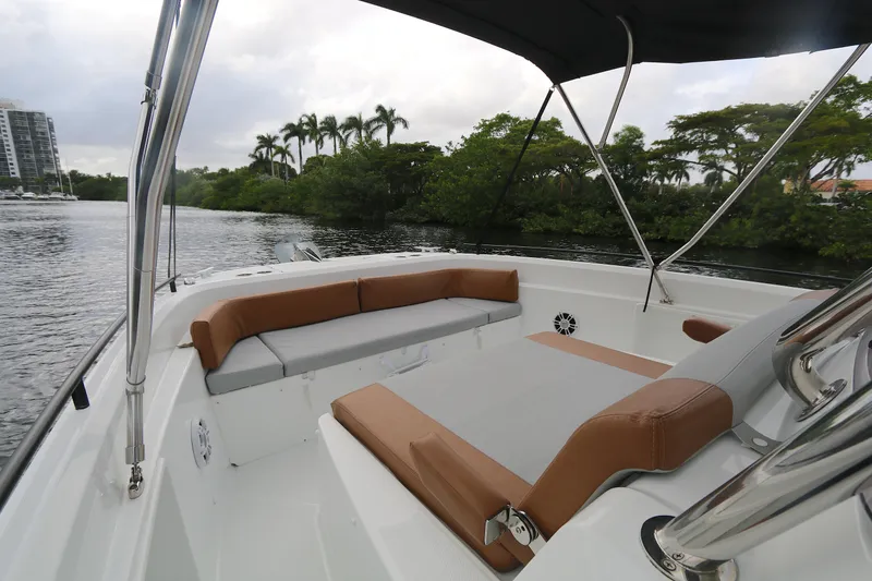 Slide: The Image of 2022 Beneteau Flyer 9 SPACEdeck boat interior with seating, near lush greenery and waterway. - 9
