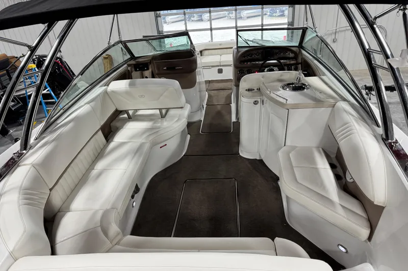 Slide: The Image of Interior of a 2007 Cobalt 302 boat with white seating and modern amenities. - 10