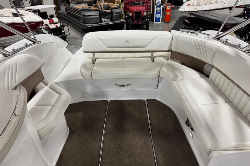 Slide: The Image of 2007 Cobalt 302 boat interior with white leather seating and brown carpet flooring. - 4