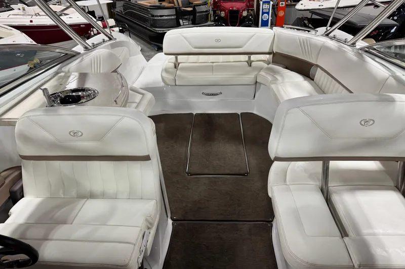 Slide: The Image of Interior of a 2007 Cobalt 302 boat with white leather seating and carpeted floor. - 5