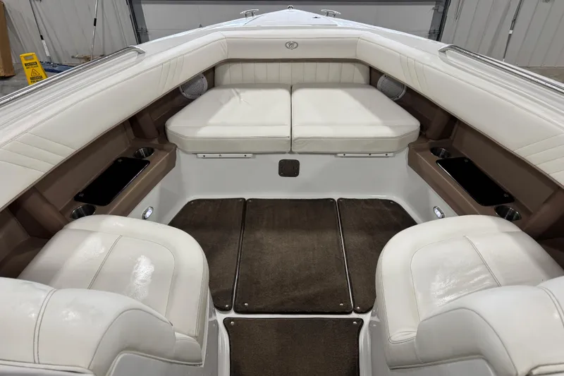Slide: The Image of Interior of a 2007 Cobalt 302 boat with white leather seating and brown accents. - 6
