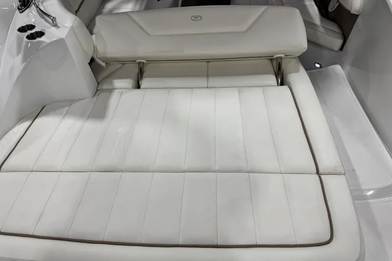 Slide: The Image of 2007 Cobalt 302 boat interior with white cushioned seating and sleek design. - 7
