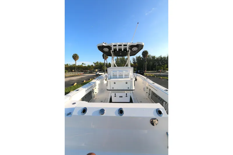Slide: The Image of 2021 BLACWATER 252CC boat interior with console, parked outdoors under clear blue sky. - 13