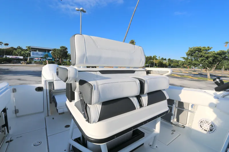 Slide: The Image of 2021 BLACWATER 252CC boat interior with cushioned seating and clear blue sky. - 2