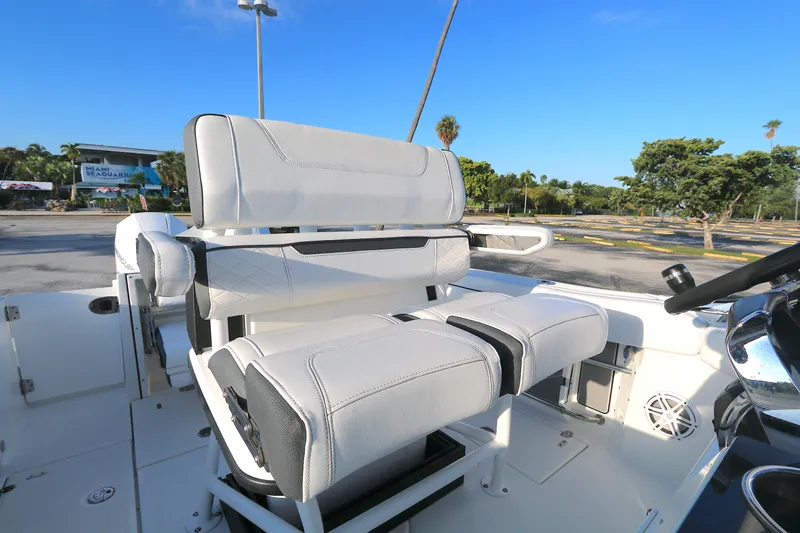 Slide: The Image of 2021 BLACWATER 252CC boat seating with white upholstery, parked near Miami Seaquarium. - 3
