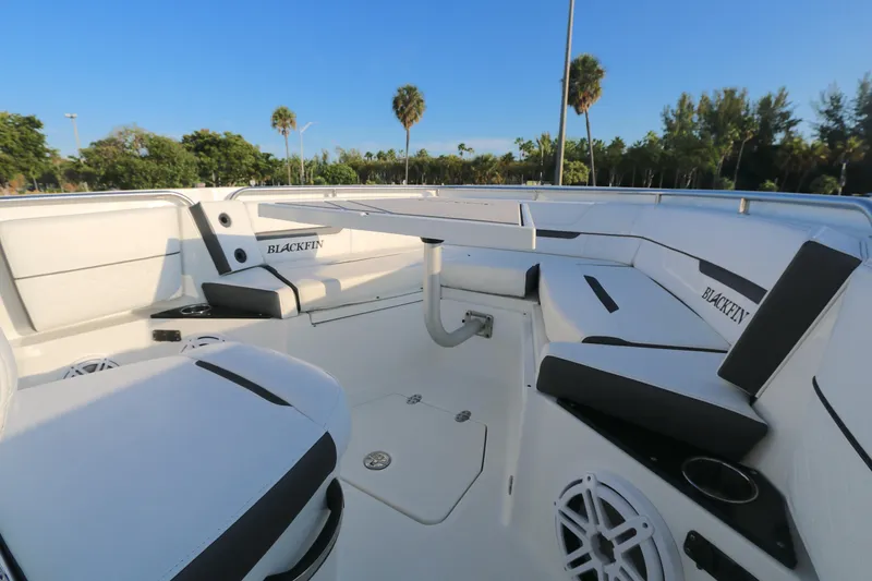 Slide: The Image of 2021 BLACWATER 252CC boat interior with white seating and blue sky background. - 5
