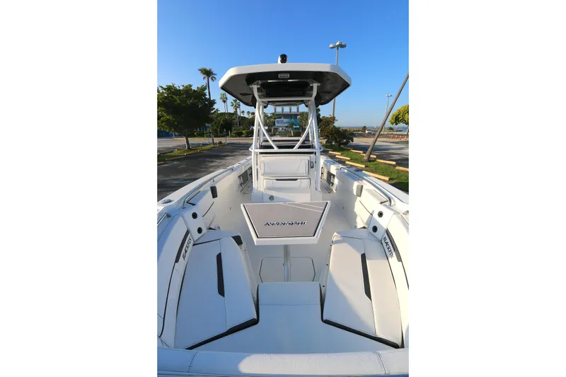 Slide: The Image of 2021 BLACWATER 252CC boat interior with seating and console, parked outdoors. - 7