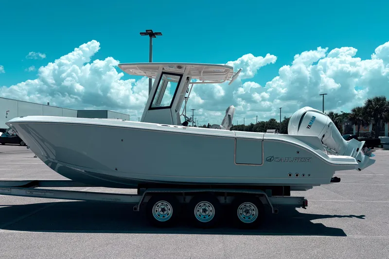 The Image of 2026 Sailfish 252 CC boat on trailer under a bright blue sky. - 0