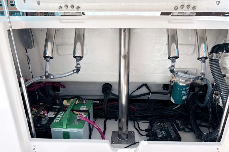 Slide: The Image of 2026 Sailfish 252 CC boat engine compartment with batteries and wiring. - 11