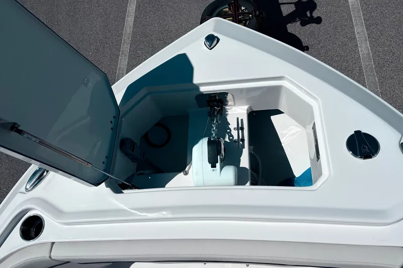 Slide: The Image of 2026 Sailfish 252 CC boat anchor compartment with open hatch, showcasing storage space. - 16
