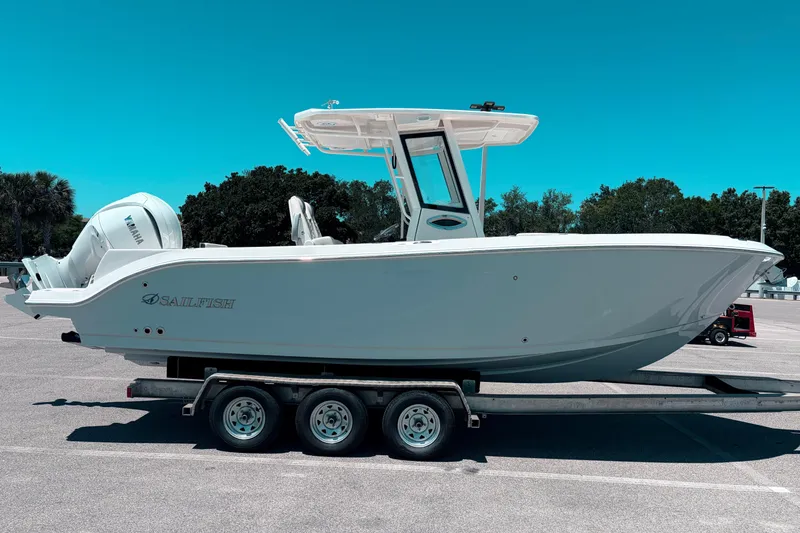 Slide: The Image of 2026 Sailfish 252 CC boat on trailer, parked in sunny lot. - 2