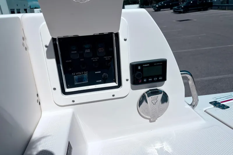 Slide: The Image of Control panel of 2026 Sailfish 252 CC boat with electronic displays and switches. - 23