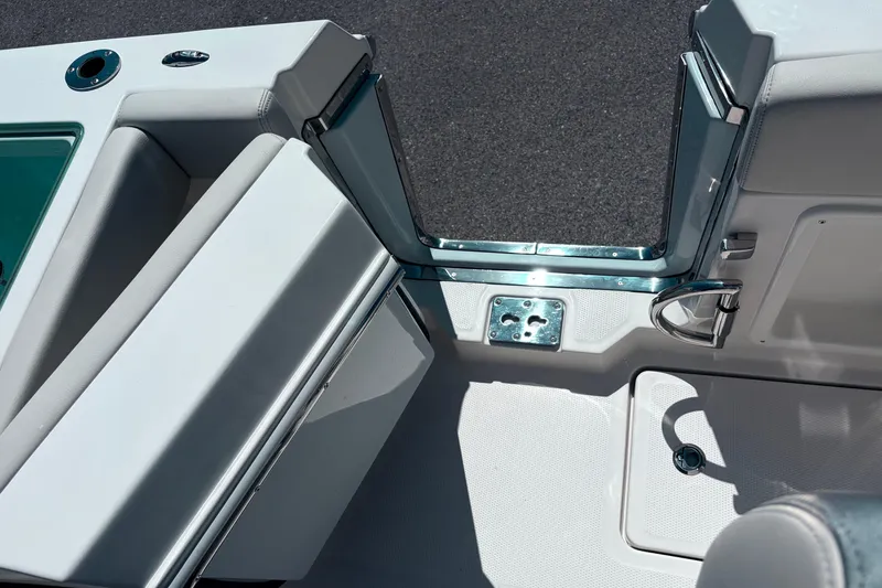 Slide: The Image of 2026 Sailfish 252 CC boat interior with open door and seating area. - 25