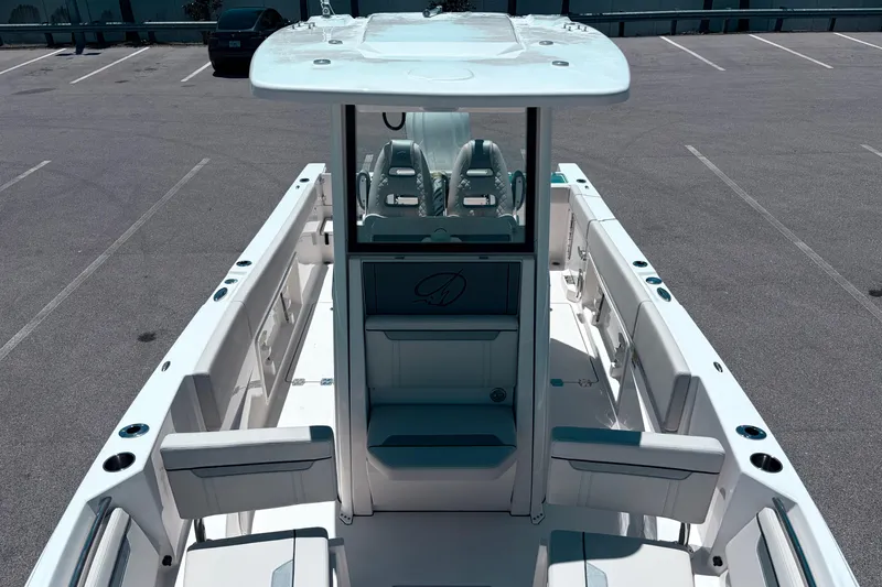 Slide: The Image of 2026 Sailfish 252 CC boat interior with seating and console in a parking lot. - 26