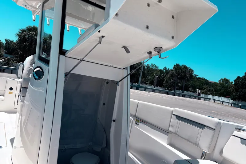 Slide: The Image of 2026 Sailfish 252 CC boat interior with open storage compartment and seating. - 27
